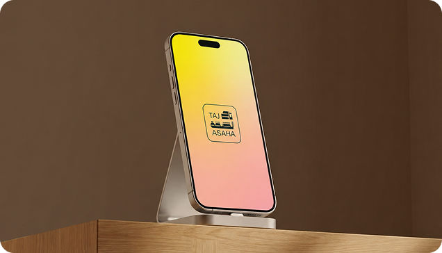 Smartphone on a stand displaying the Taj Asaha app