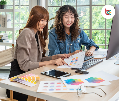 Designers collaborating on brand concepts with colour palettes and sketches